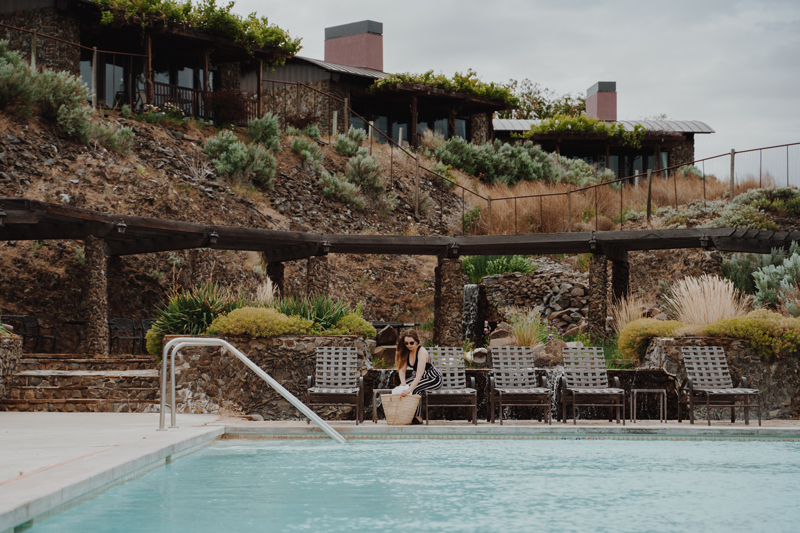 Featured image of woman by pool at SageCliffe Resort